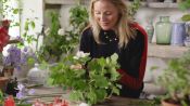 Willow Crossley creates a flower arrangement for a summer table