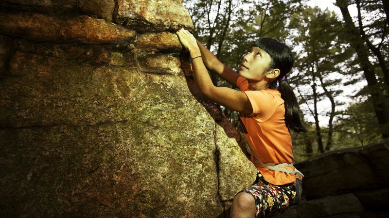 Man & woman sort rock climbing gear during early morning in