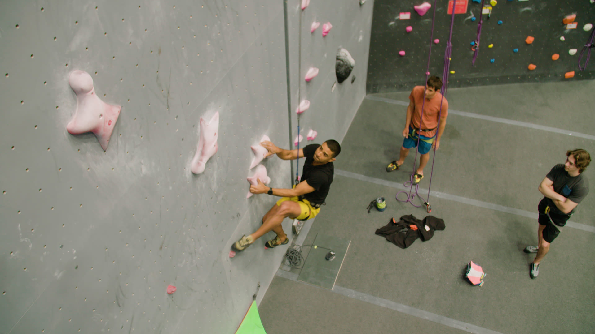 Sporty couple of climbers dressed in rock climbing outfit training